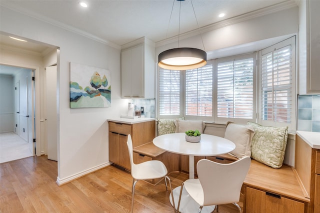 dining room featuring recessed lighting, baseboards, ornamental molding, light wood-type flooring, and breakfast area