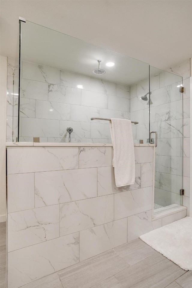 bathroom with a marble finish shower