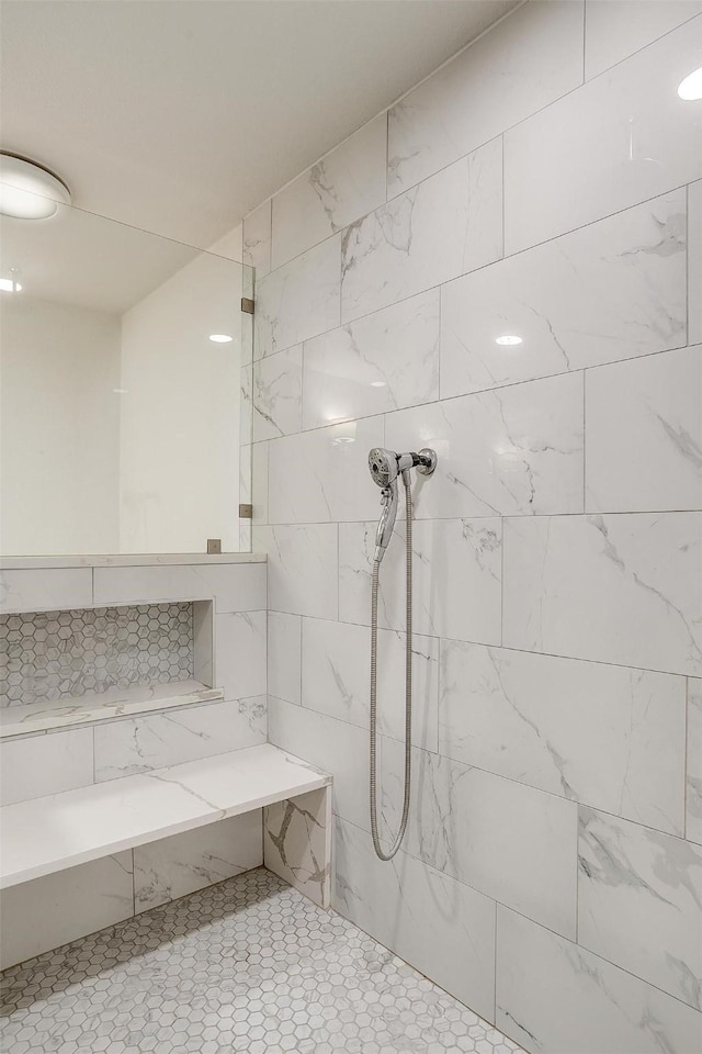 bathroom with a tile shower