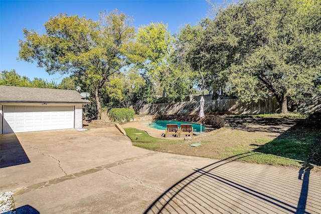 view of pool with fence, a fenced in pool, and an outdoor structure