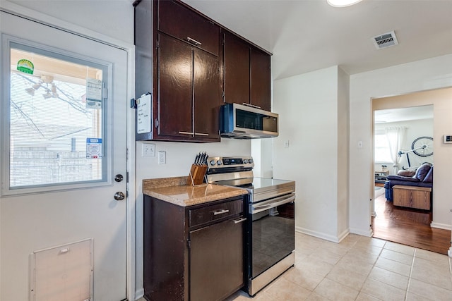 kitchen with stainless steel appliances, a healthy amount of sunlight, visible vents, and light tile patterned floors