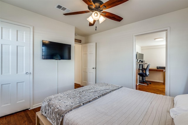 bedroom featuring a ceiling fan, dark wood-style flooring, and visible vents