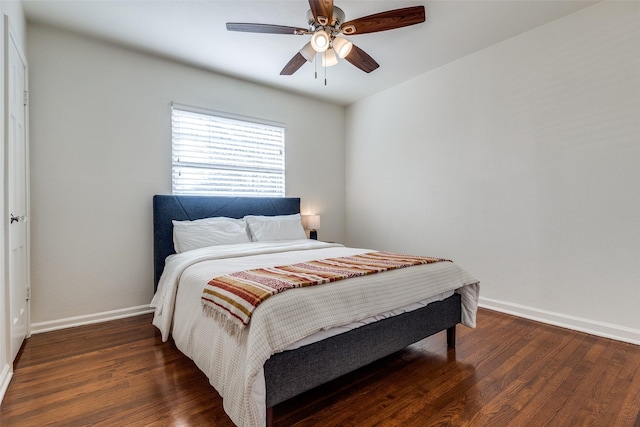 bedroom with a ceiling fan, baseboards, and wood finished floors