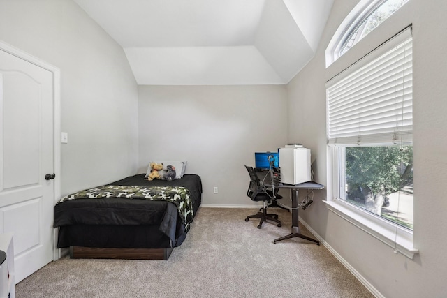 bedroom featuring lofted ceiling, baseboards, and carpet