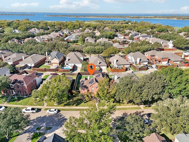 birds eye view of property with a water view and a residential view