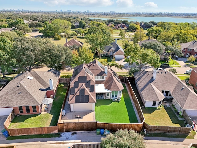 drone / aerial view featuring a water view and a residential view