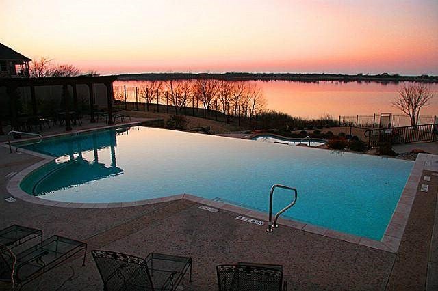 community pool featuring a patio area and a water view