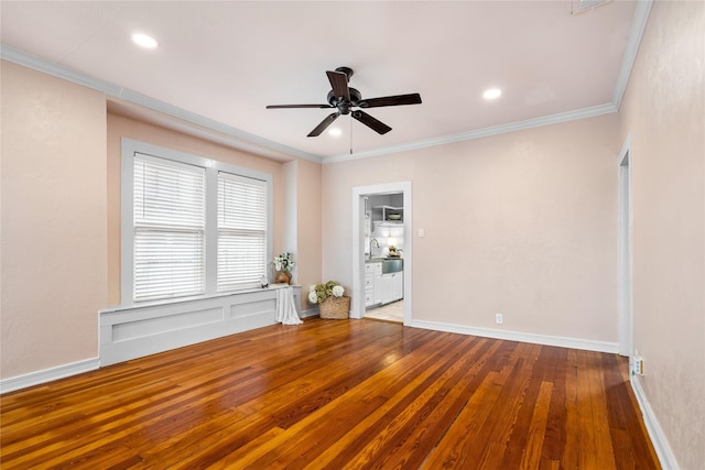 spare room with ornamental molding, baseboards, and hardwood / wood-style flooring