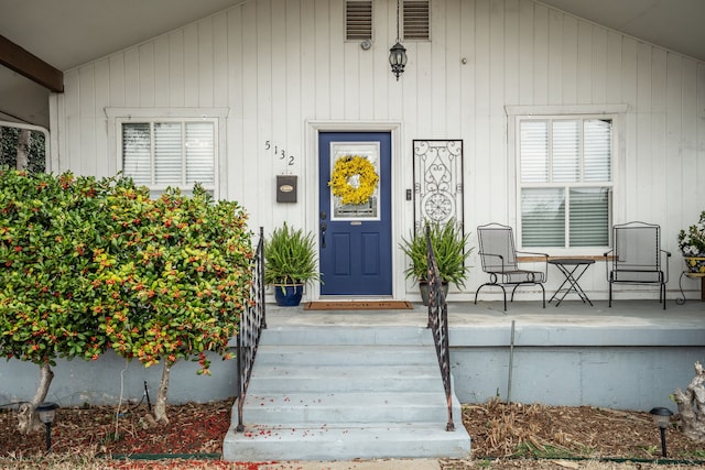 view of exterior entry with covered porch