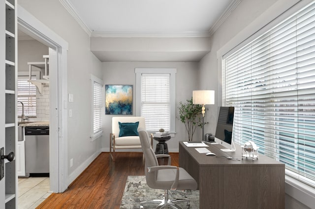 office area with ornamental molding, light wood-style flooring, and baseboards