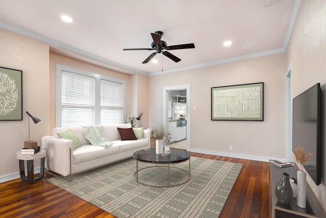 living area featuring hardwood / wood-style flooring, baseboards, and ornamental molding