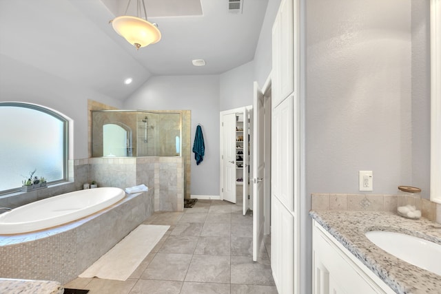 full bathroom featuring lofted ceiling, a garden tub, vanity, visible vents, and a shower stall