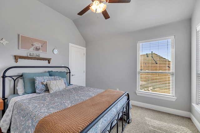 carpeted bedroom featuring vaulted ceiling, a ceiling fan, and baseboards