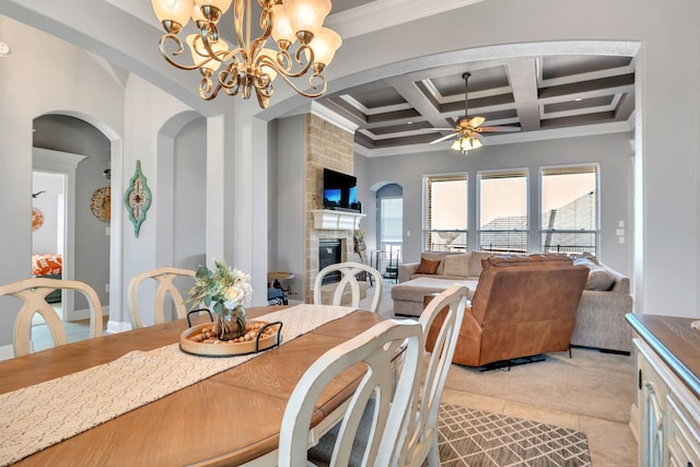 dining space featuring light tile patterned flooring, a fireplace, coffered ceiling, beam ceiling, and crown molding