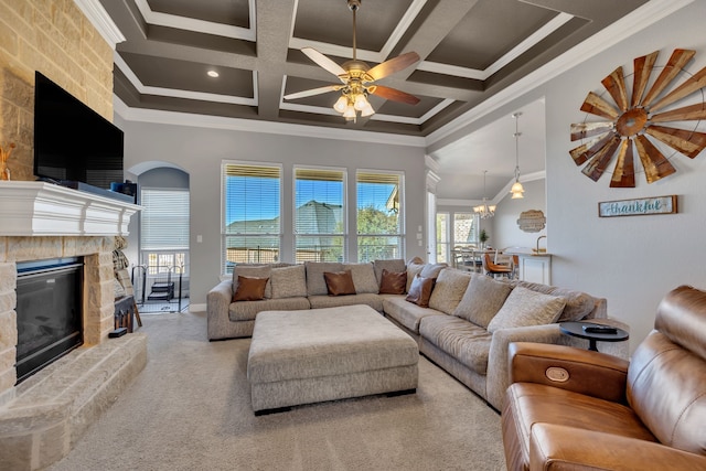 living area featuring ornamental molding, carpet flooring, a fireplace, and a towering ceiling