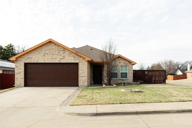 single story home featuring driveway, brick siding, an attached garage, and fence