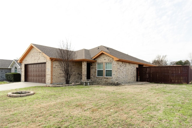 ranch-style home featuring a front yard, brick siding, and an attached garage