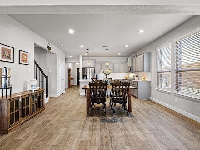 dining space with recessed lighting, stairway, light wood-type flooring, and baseboards