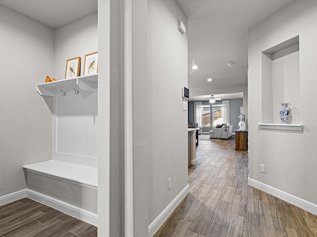 mudroom featuring baseboards and wood finished floors