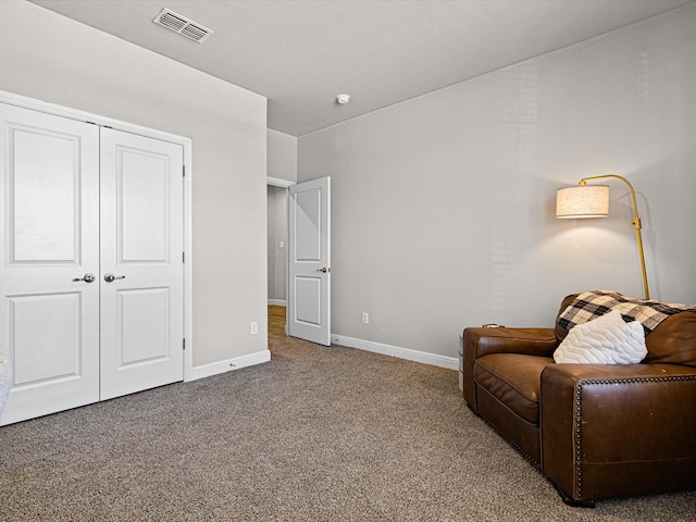 sitting room with carpet, visible vents, and baseboards