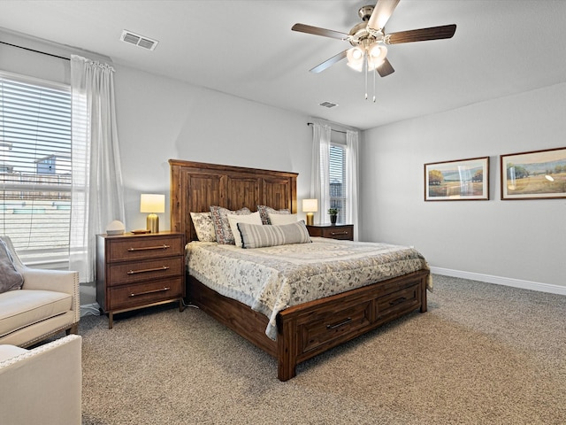 bedroom featuring light carpet, ceiling fan, visible vents, and baseboards