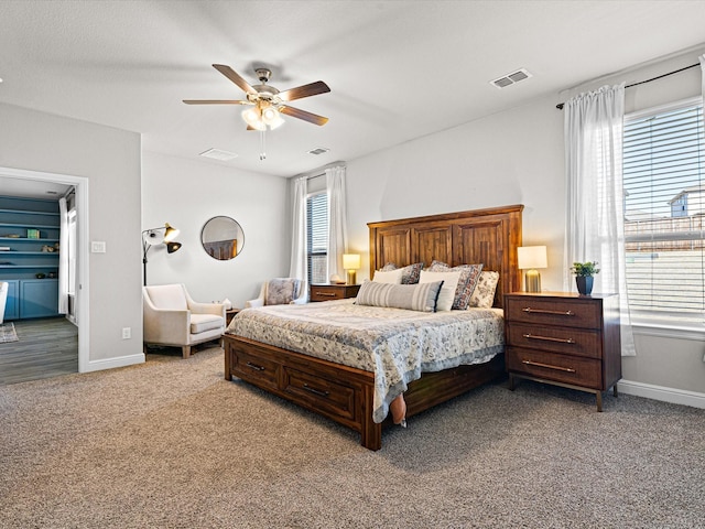 bedroom featuring light colored carpet, visible vents, and baseboards