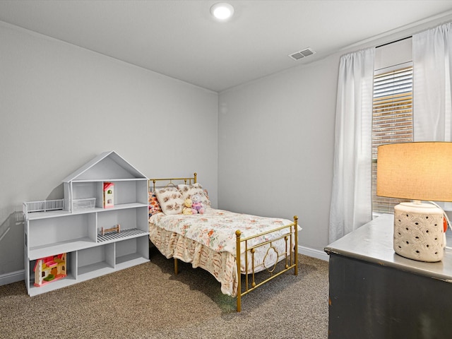 carpeted bedroom featuring visible vents and baseboards