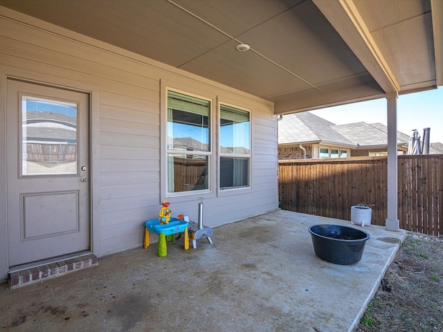 view of patio featuring fence