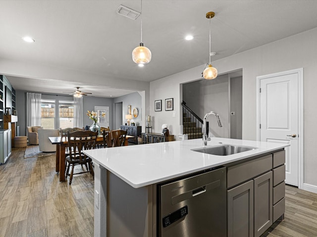 kitchen with visible vents, dishwasher, open floor plan, gray cabinetry, and a sink