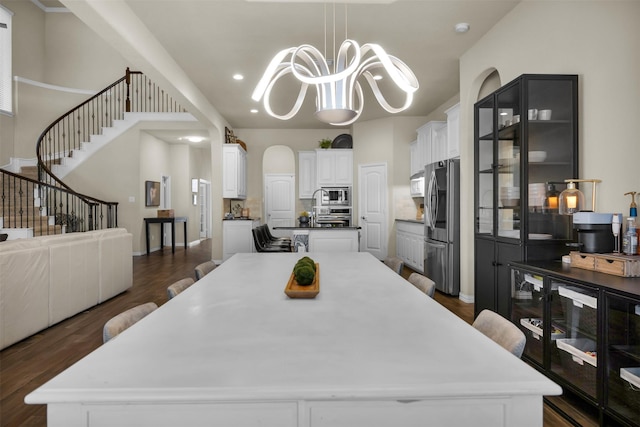 2822 Palmerston Dr, Midlothian, TX 76065 - dining space with dark wood-style flooring, a chandelier, recessed lighting, and stairs