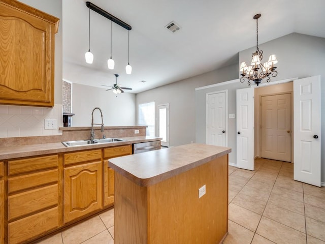 kitchen featuring light tile patterned floors, tasteful backsplash, visible vents, a kitchen island, and a sink