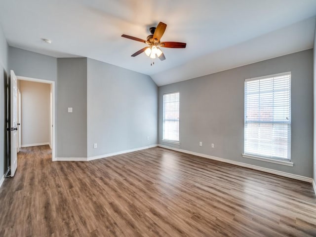 empty room featuring ceiling fan, wood finished floors, and baseboards