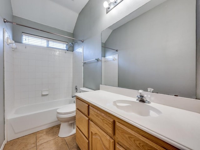 bathroom with lofted ceiling, toilet, washtub / shower combination, vanity, and tile patterned flooring