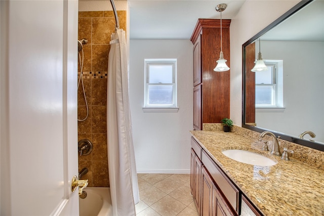 full bath with shower / bath combo, plenty of natural light, vanity, and tile patterned floors