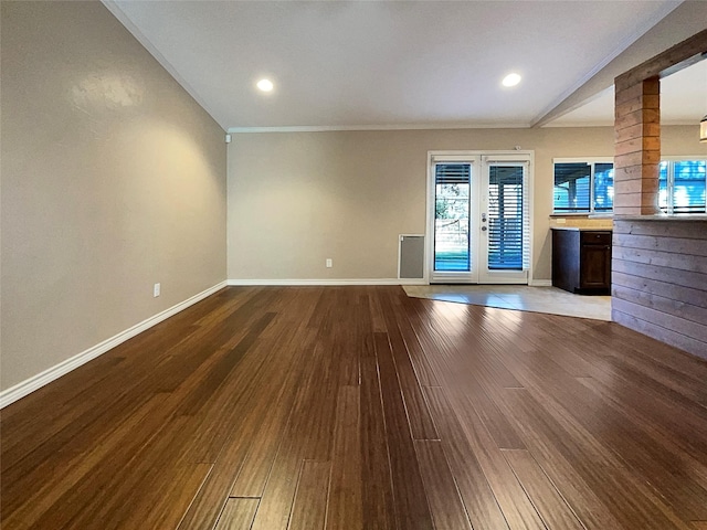 unfurnished living room featuring recessed lighting, baseboards, dark wood finished floors, and french doors