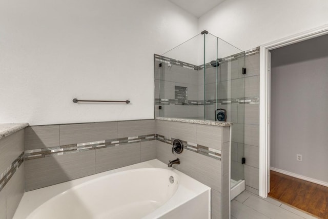 full bath featuring a shower stall and a bath