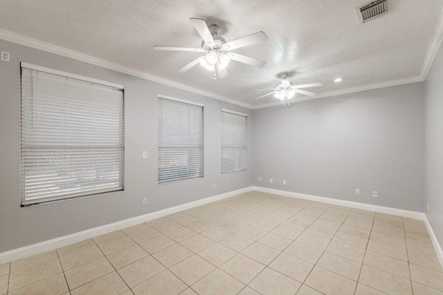 unfurnished room with a ceiling fan, baseboards, visible vents, and crown molding