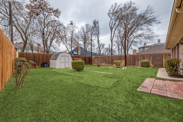 view of yard with a storage shed, a fenced backyard, a patio, and an outdoor structure