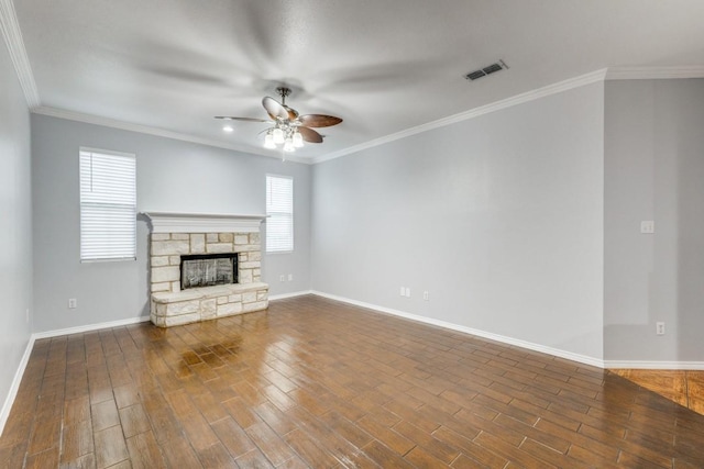 unfurnished living room featuring dark wood-style floors, plenty of natural light, a fireplace, and visible vents