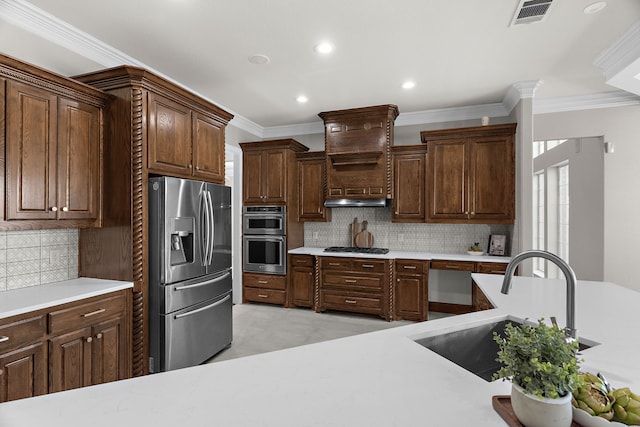 100 Bailee Ct, Forney, TX 75126 - kitchen featuring appliances with stainless steel finishes, crown molding, light countertops, a sink, and backsplash