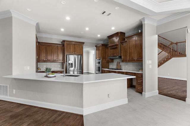 100 Bailee Ct, Forney, TX 75126 - kitchen featuring stainless steel appliances, a peninsula, light countertops, crown molding, and recessed lighting