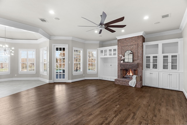 100 Bailee Ct, Forney, TX 75126 - unfurnished living room featuring ceiling fan, a chandelier, a brick fireplace, crown molding, and dark wood finished floors