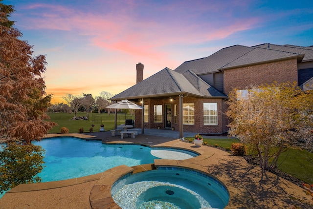 100 Bailee Ct, Forney, TX 75126 - view of swimming pool featuring a patio area, a lawn, and a pool with connected hot tub