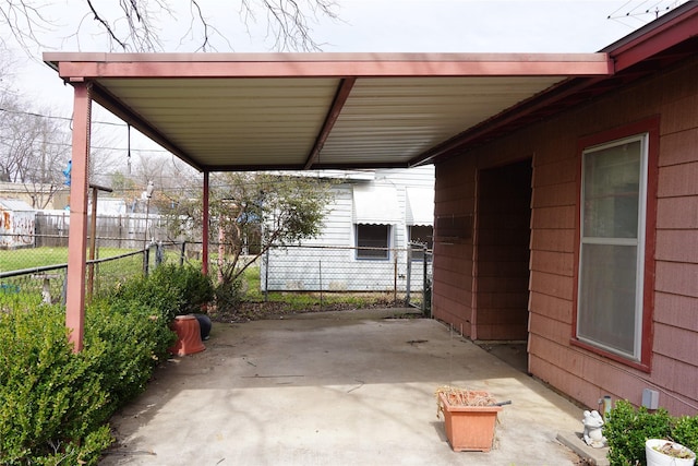 view of patio / terrace with fence and an attached carport