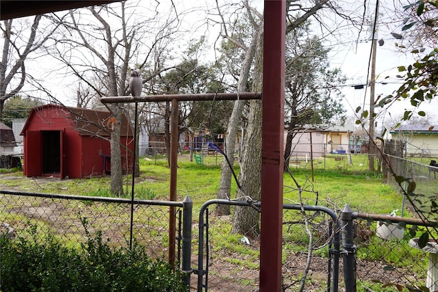 view of yard featuring fence private yard, a gate, and an outbuilding