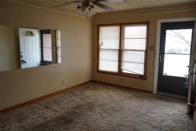 interior space with ceiling fan, baseboards, and crown molding