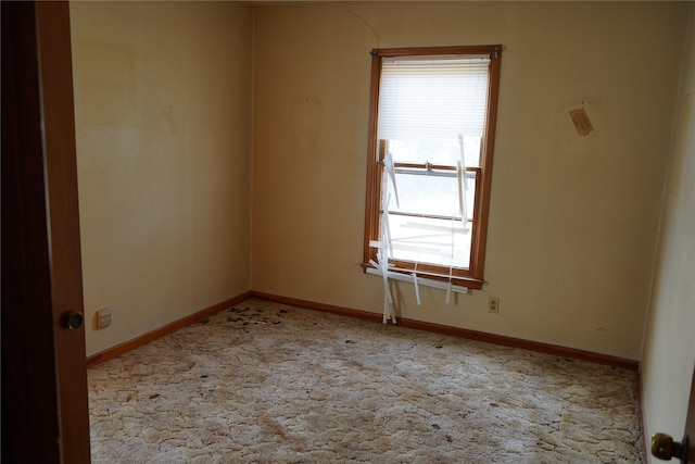 carpeted spare room with baseboards