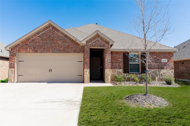 ranch-style home featuring a shingled roof, concrete driveway, an attached garage, a front lawn, and brick siding