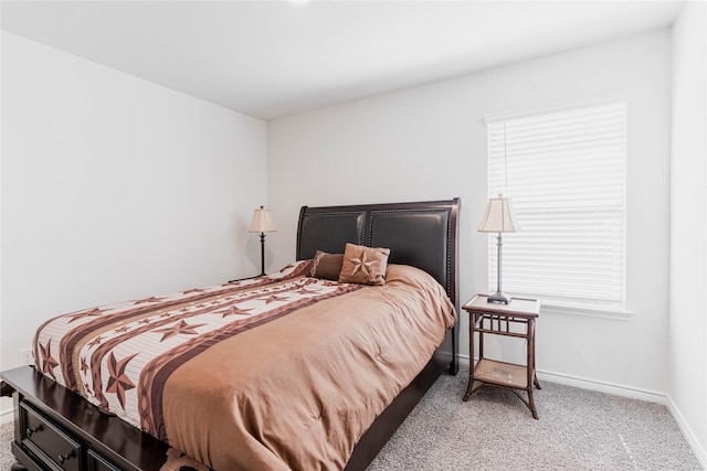 bedroom featuring carpet floors and baseboards