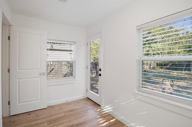 entryway featuring light wood-style floors and baseboards